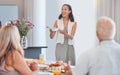 Woman, excited and serving family at thanksgiving dining table in house or home for celebration event, holiday or buffet