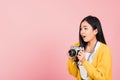 Woman excited smiling photographer holding retro vintage photo camera Royalty Free Stock Photo