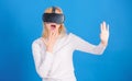 Woman excited using 3d goggles. Woman wearing virtual reality goggles in blue background. Woman using virtual reality Royalty Free Stock Photo