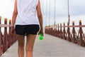 Woman exercise walking on the bridge with bottle water in her hand. Royalty Free Stock Photo