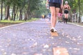 Woman exercise walking in the park with hand holding bottle water in morning. Royalty Free Stock Photo