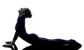 Woman exercising bhujangasana cobra pose yoga silhouette Royalty Free Stock Photo