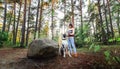 Woman exercising with Dalmatian dog in forest Royalty Free Stock Photo