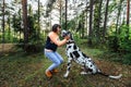 Woman exercising with Dalmatian dog in forest Royalty Free Stock Photo