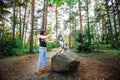 Woman exercising with Dalmatian dog in forest Royalty Free Stock Photo