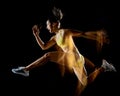 Woman exercising fitness exercises isolated black background lightpainting effect Royalty Free Stock Photo