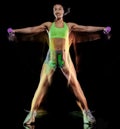 Woman exercising fitness exercises isolated black background lightpainting effect Royalty Free Stock Photo