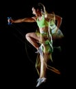 Woman exercising fitness exercises isolated black background lightpainting effect