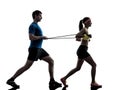 Woman exercising fitness resistance rubber band with man coach