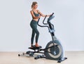 Woman exercising at the gym on crosstrainer