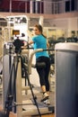 Woman exercising in gym with exercise-machine - leg day, wellbeing concept Royalty Free Stock Photo