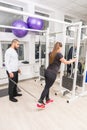 Woman exercising at gym using cable machine Royalty Free Stock Photo