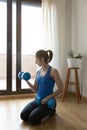 Woman exercising her muscles using a pair of dumbbells. Concept of sport at home Royalty Free Stock Photo
