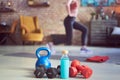 Exercising at home in living room. Focus on fitness equipments, barbell and kettlebell. Woman doing walking lunges exercise in the Royalty Free Stock Photo