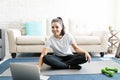 Woman exercising at home watching online videos