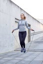 Woman exercising with jump-rope outdoors Royalty Free Stock Photo