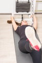 Woman exercising legs on cable machine at gym Royalty Free Stock Photo