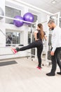 Woman exercising legs with personal trainer assist Royalty Free Stock Photo