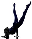 Woman exercising Mayurasana peacock pose yoga silhouette