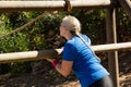 Woman exercising on outdoor equipment during obstacle course training Royalty Free Stock Photo