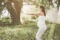 Woman exercising in outdoor. Young woman in meadow.