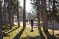 Woman exercising in park in Paris. Nordic walking in spring nature