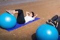 Woman exercising with pilates ball on the beach Royalty Free Stock Photo