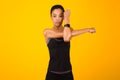 Woman Exercising Stretching Deltoid Arm Muscle Posing Over Yellow Background