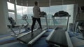 Woman exercising on treadmill in the gym
