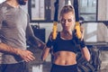 Woman exercising with trx gym equipment with trainer near by Royalty Free Stock Photo