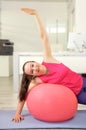 Woman exercising using a fitness ball Royalty Free Stock Photo