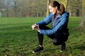 Woman Exercising In Winter Park Looking At Activity Tracker On Smart Watch Royalty Free Stock Photo