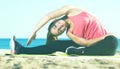 Woman exercising yoga at sea beach Royalty Free Stock Photo