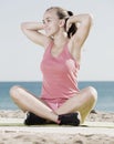 Woman exercising yoga at sea beach Royalty Free Stock Photo