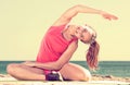 Woman exercising yoga at sea beach Royalty Free Stock Photo