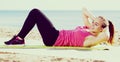 Woman exercising yoga at sea beach Royalty Free Stock Photo