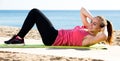 Woman exercising yoga at sea beach Royalty Free Stock Photo