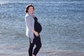 Pregnant woman by the water