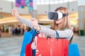 Woman experience shopping online with VR headset