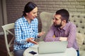 Woman explaining something to serious handsome man Royalty Free Stock Photo