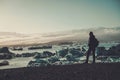 Woman explorer lookig at Jokulsarlon lagoon, Iceland.