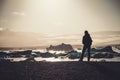 Woman explorer lookig at Jokulsarlon lagoon, Iceland.