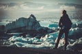 Woman explorer lookig at Jokulsarlon lagoon, Iceland.