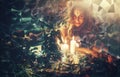 A woman explores mysticism with candles, shards, and the presence of Hecate, the goddess of magic.