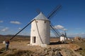 Woman, historic windmills of Consuegra, and plains of La Mancha