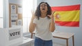 Woman expressing frustration in a voting room with a spain flag in the background, emphasizing the electoral setting and spanish Royalty Free Stock Photo