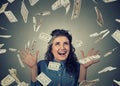 Woman exults pumping fists ecstatic celebrates success under money rain falling down dollar bills banknotes Royalty Free Stock Photo