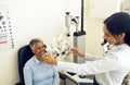 Woman, eye exam and phoropter for ophthalmologist with check, lens or vision for wellness in clinic. Doctor, eyesight Royalty Free Stock Photo