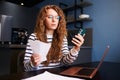 Woman in eyeglasses calculates expenses on bills, increased utilities prices list. Female book-keeping income paychecks Royalty Free Stock Photo