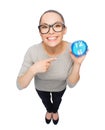 Woman in eyeglasses pointing finger to blue clock